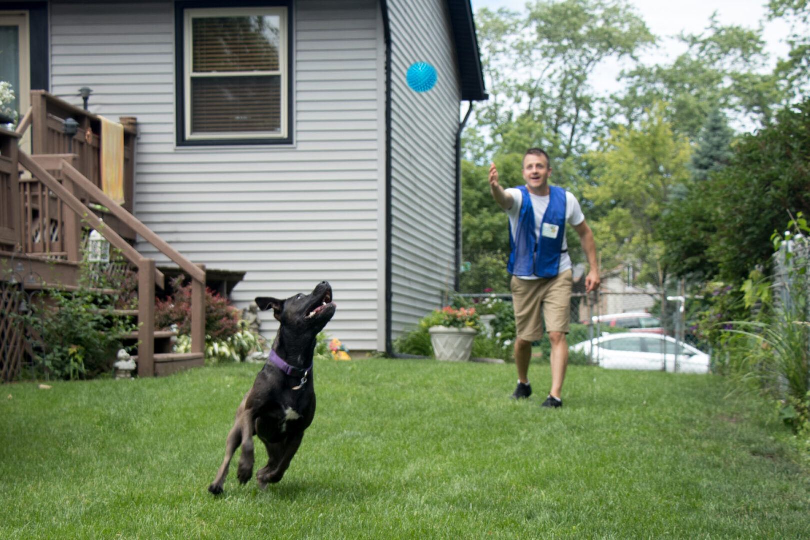#A man and his dog playing with a frisbee.